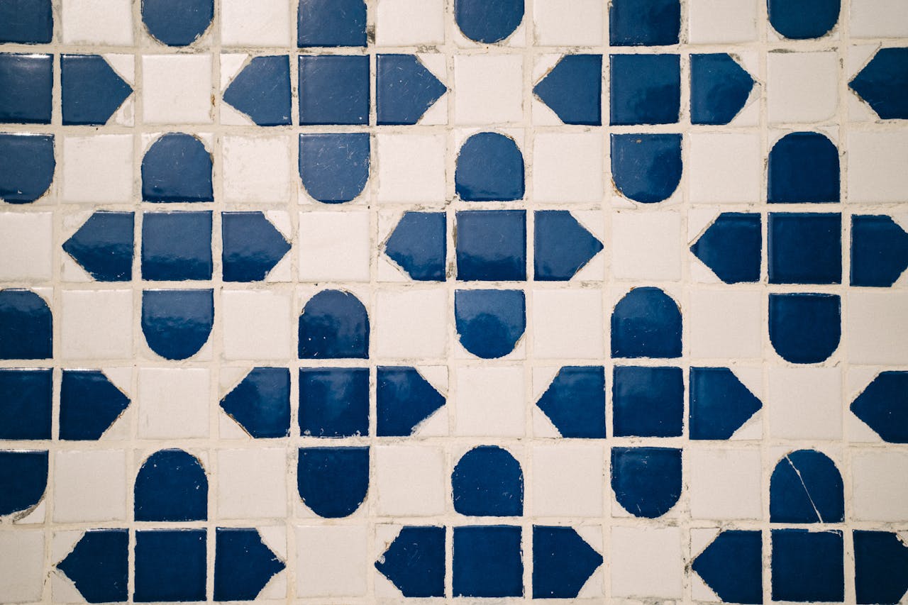 gallery-05 Detailed geometric pattern of blue and white floor tiles captured from above.